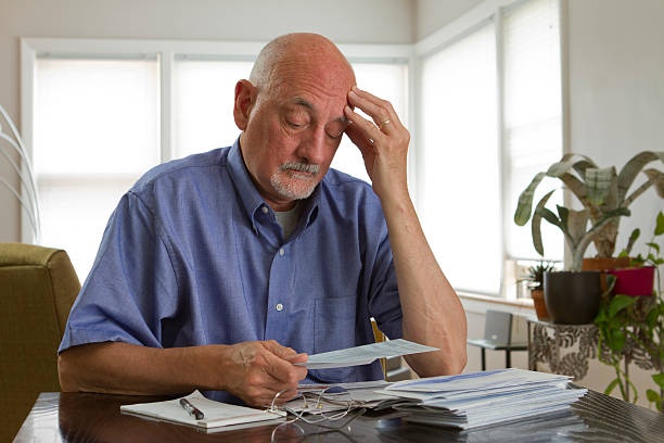 stressed person looking at bills