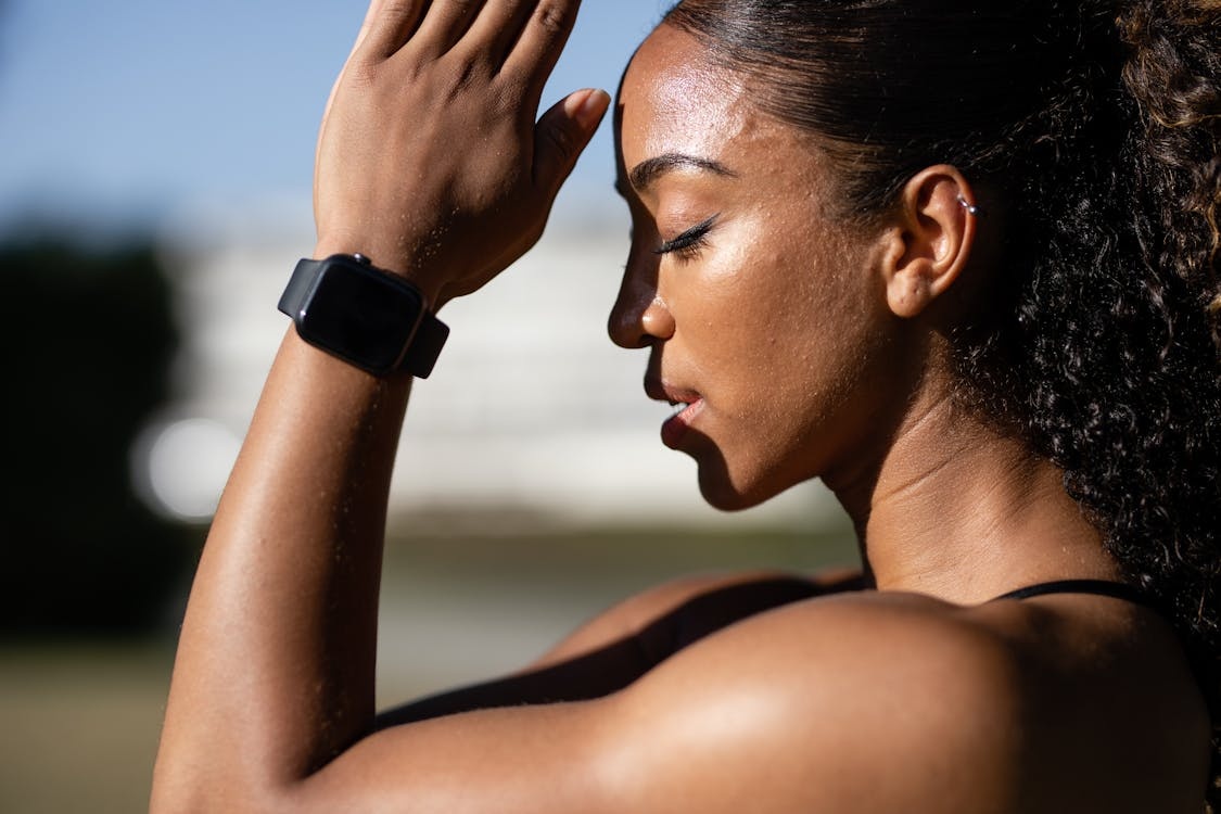 person wearing smartwatch, meditating, calm expression