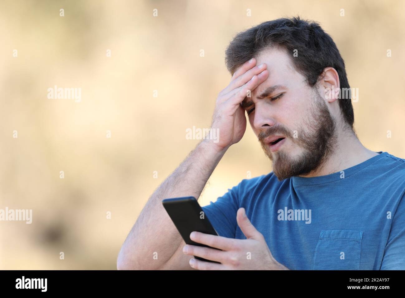 person looking at phone with concerned expression