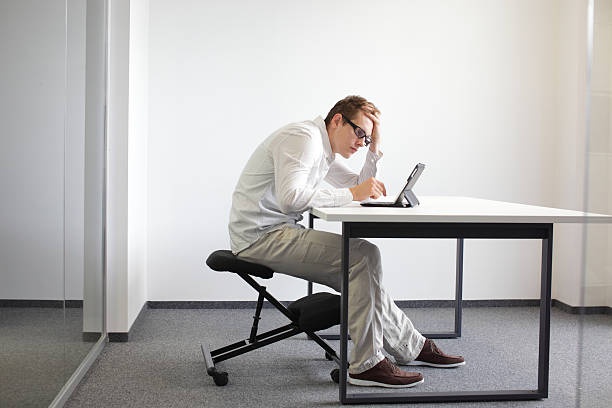 person sitting at desk with bad posture