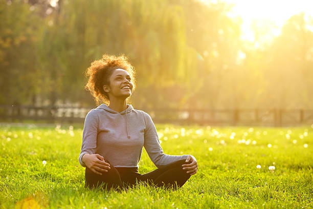 person meditating in a peaceful garden, sunlight, calm atmosphere