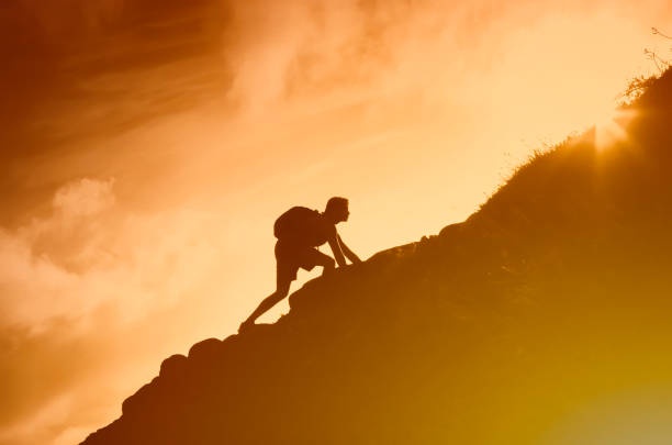 person climbing a mountain, determination