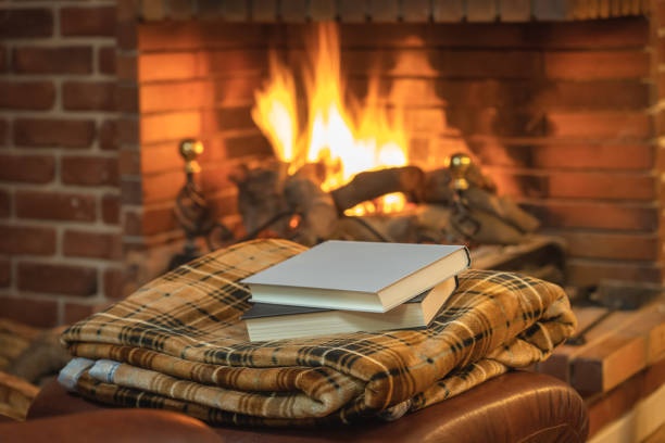 fireplace, crackling sound, cozy blanket, reading book