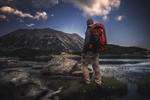 traveler,backpack,mountains,sunset
