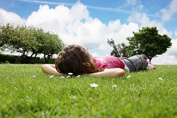 person lying in grass, looking at sky