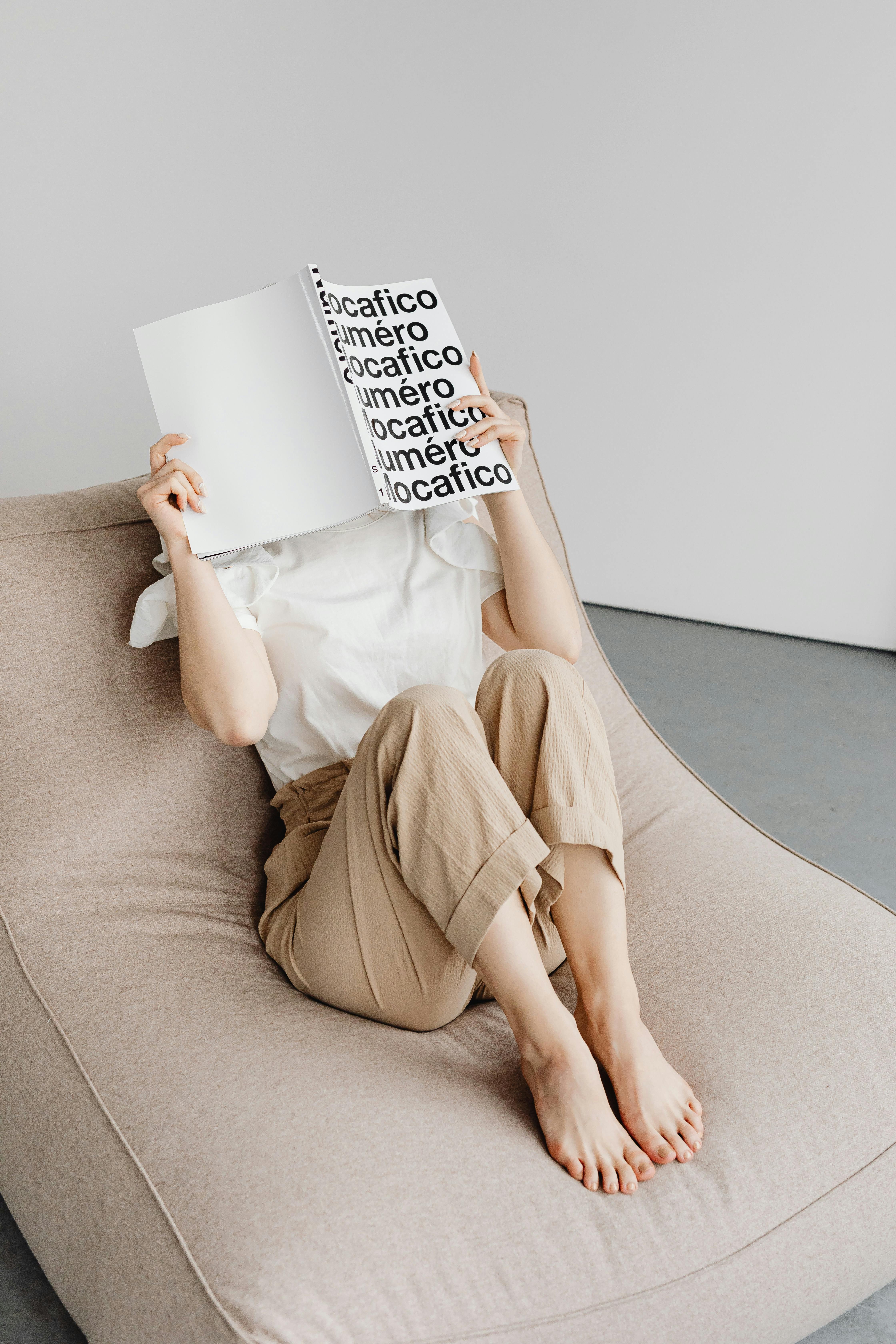 person reading, thoughtful expression, comfortable chair