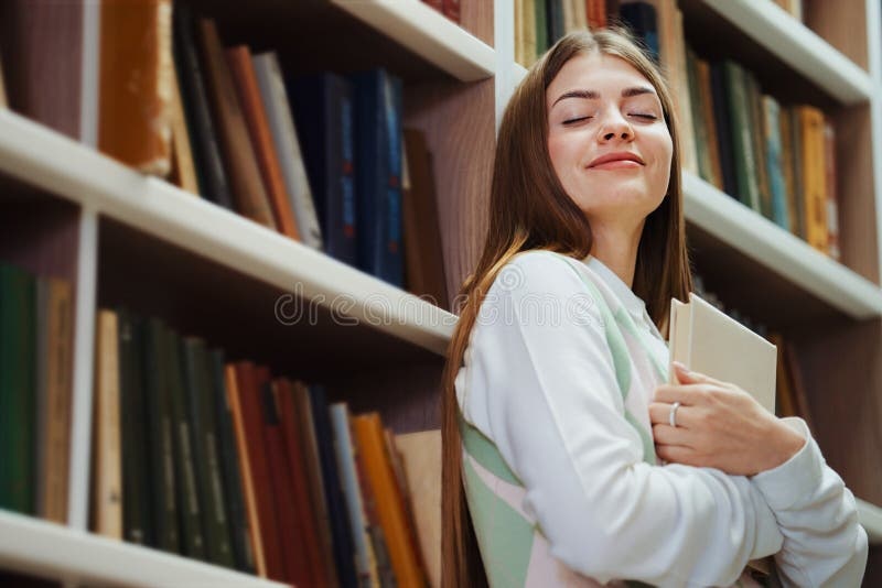 person closing a book, looking relieved