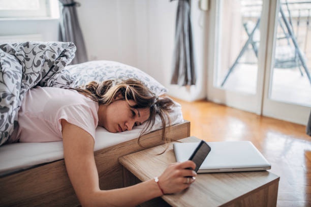 person lying in bed, tired, overwhelmed