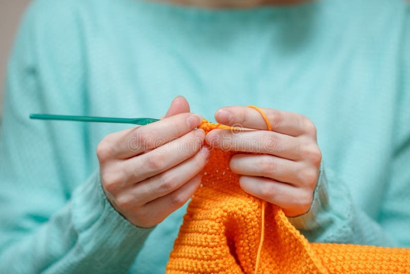 hands,crochet hook,yarn,close-up