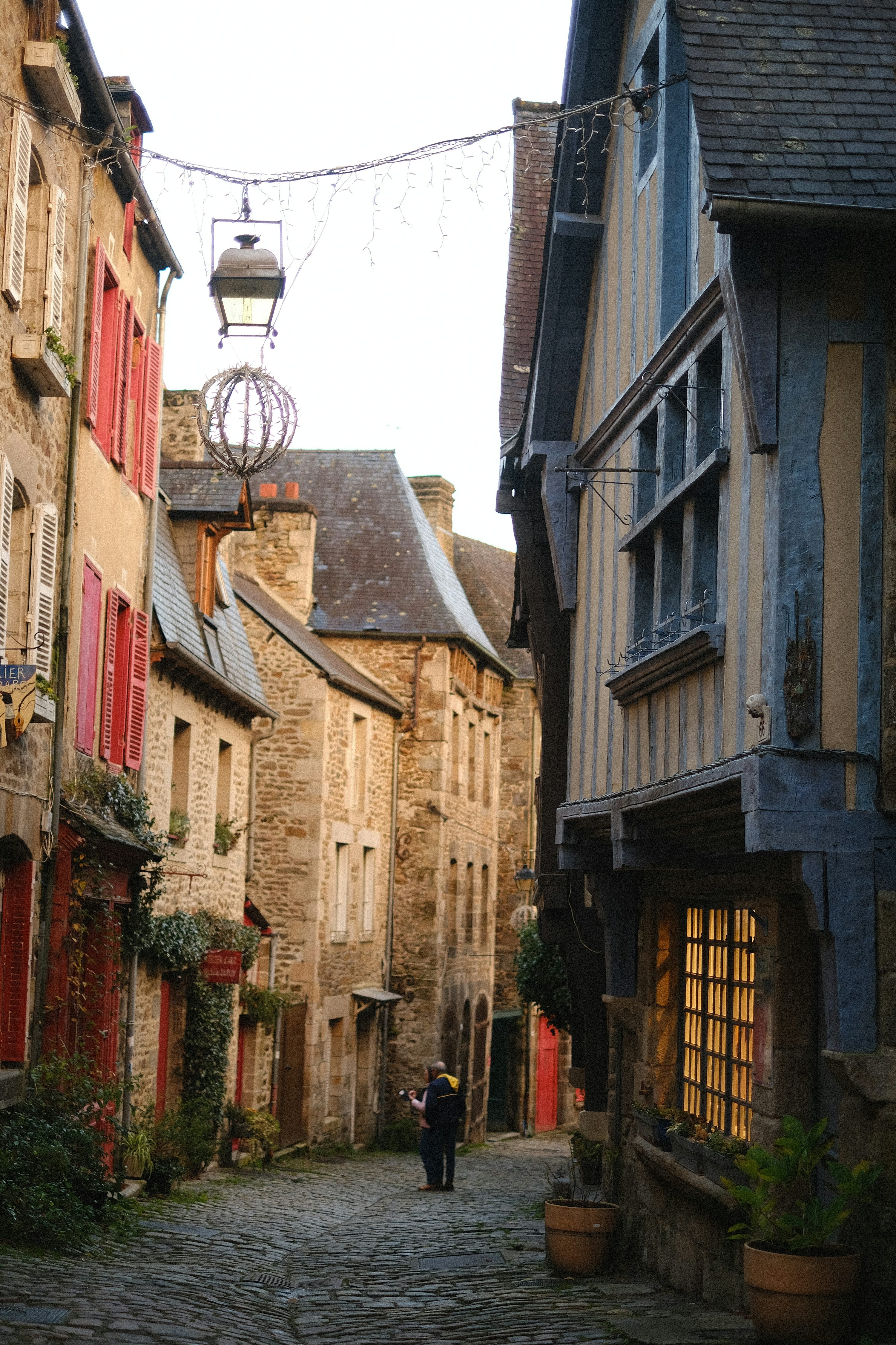 cobblestone street, european city, old buildings, sunny day