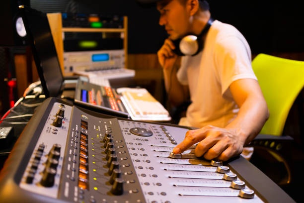 Sound engineer working on a mixing console, detailed, professional