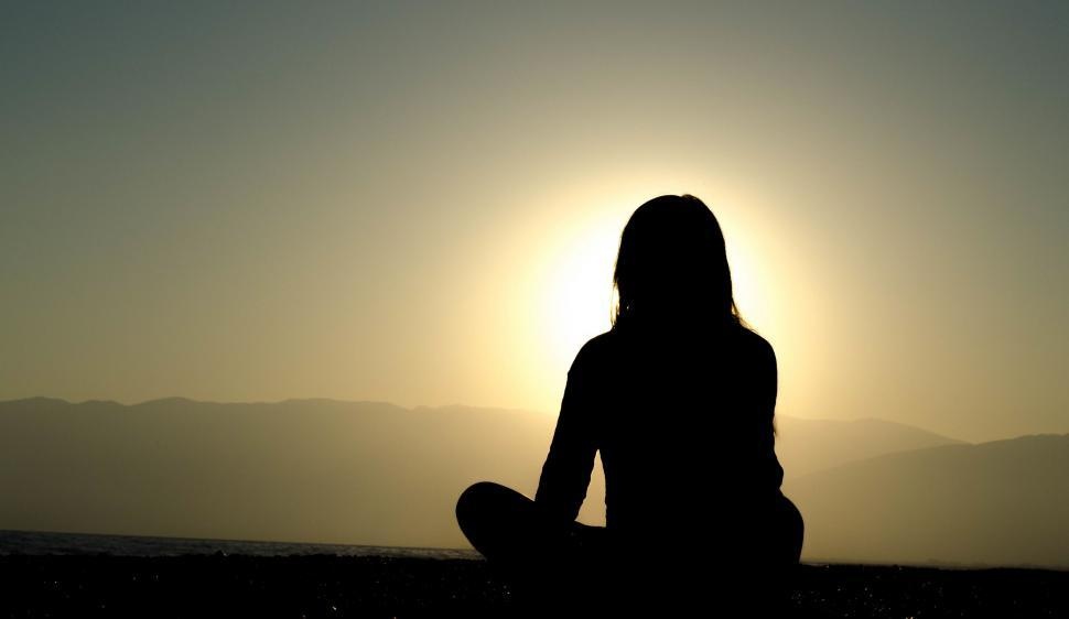 sun shining, person silhouetted against it