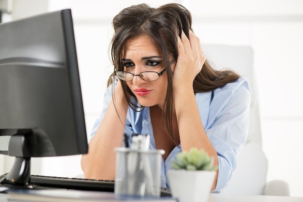 woman, stressed, hands on face, office