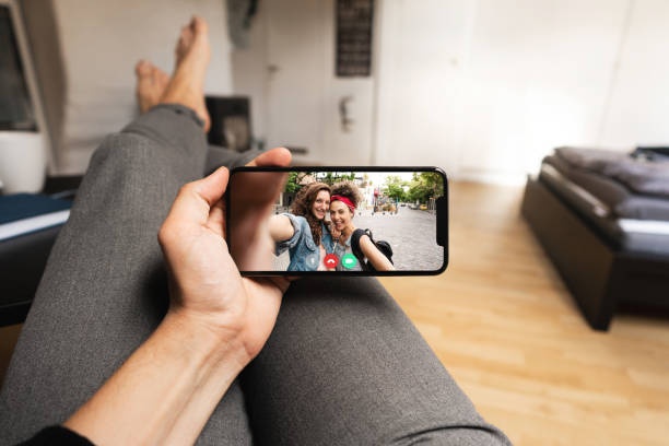 person watching a video recording of themself using a phone