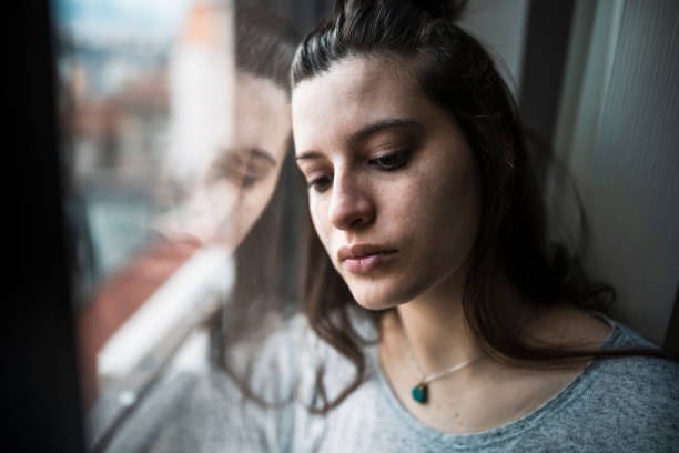 person looking down, sad expression