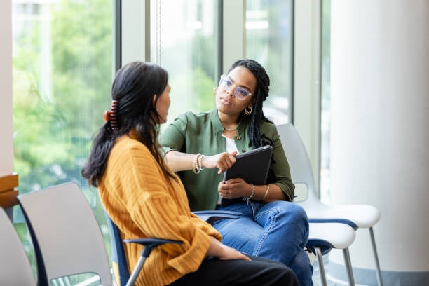 two people listening intently, nodding heads