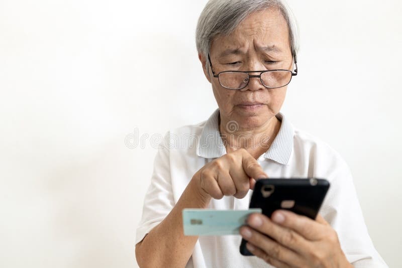 old woman holding smartphone, confused look