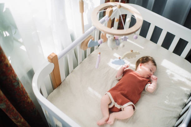 newborn baby sleeping peacefully in a bassinet