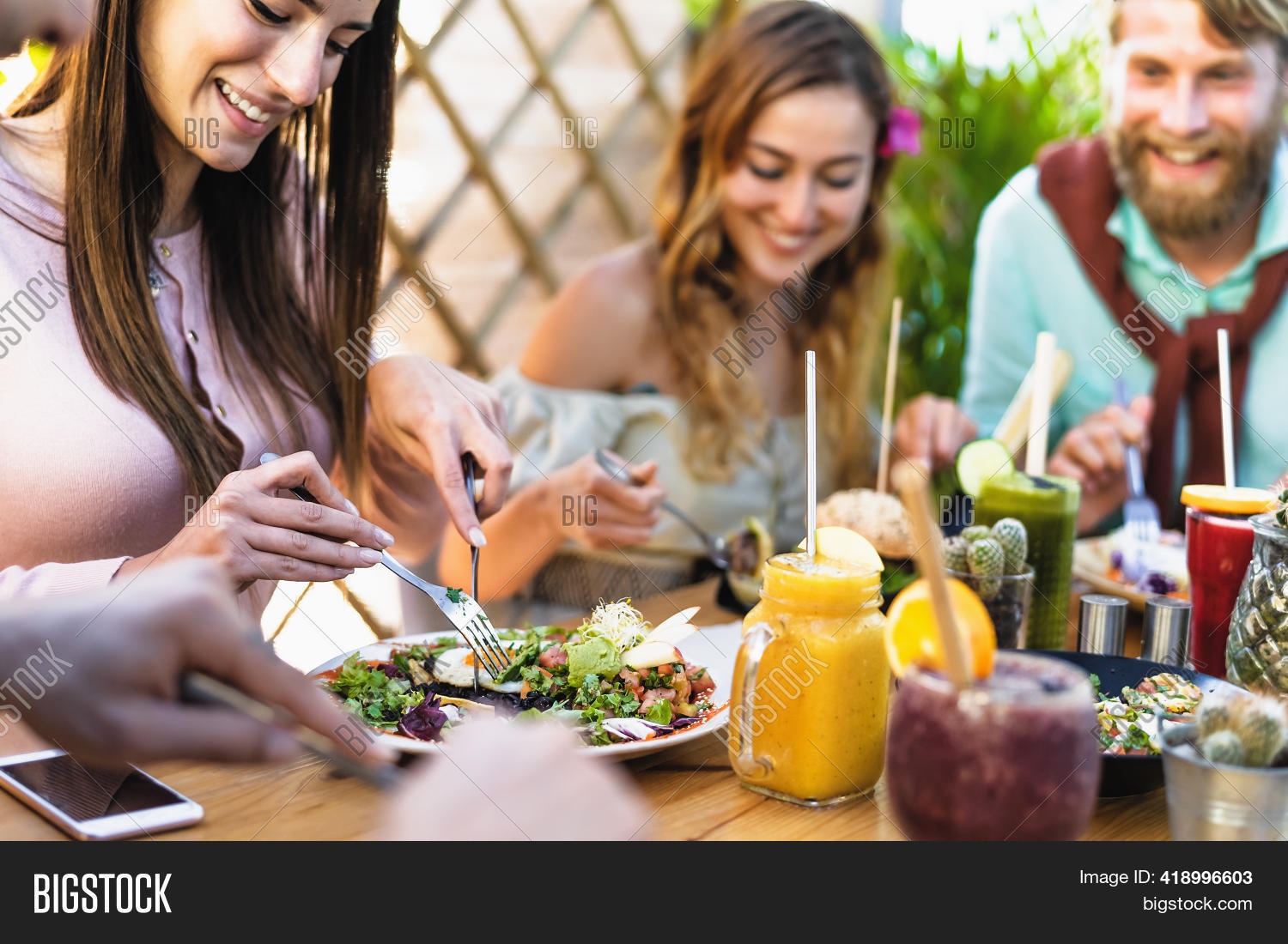 person enjoying healthy food, laughing with friends, balanced lifestyle