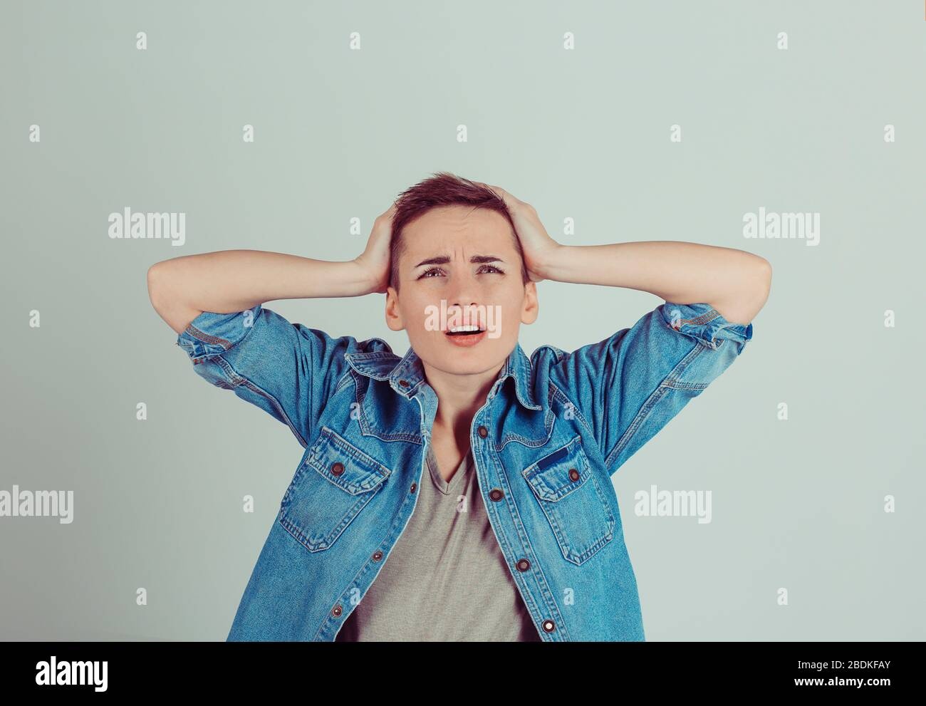 woman looking stressed, overwhelmed, hands on head