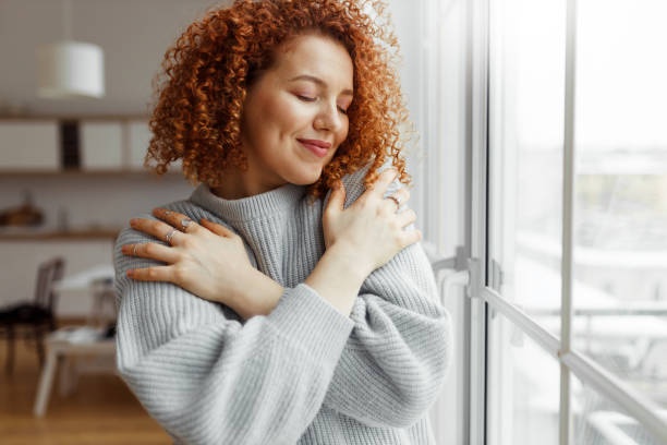 person embracing themselves, self-love, acceptance