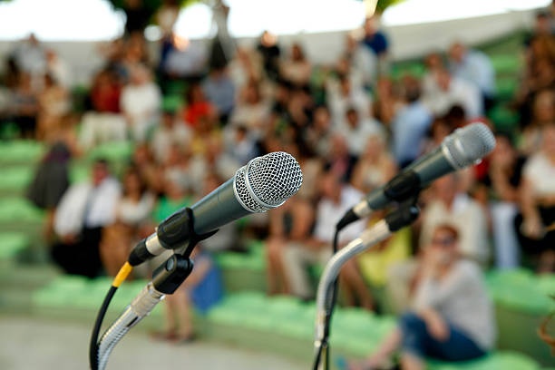 man,microphone,crowd,financial guru
