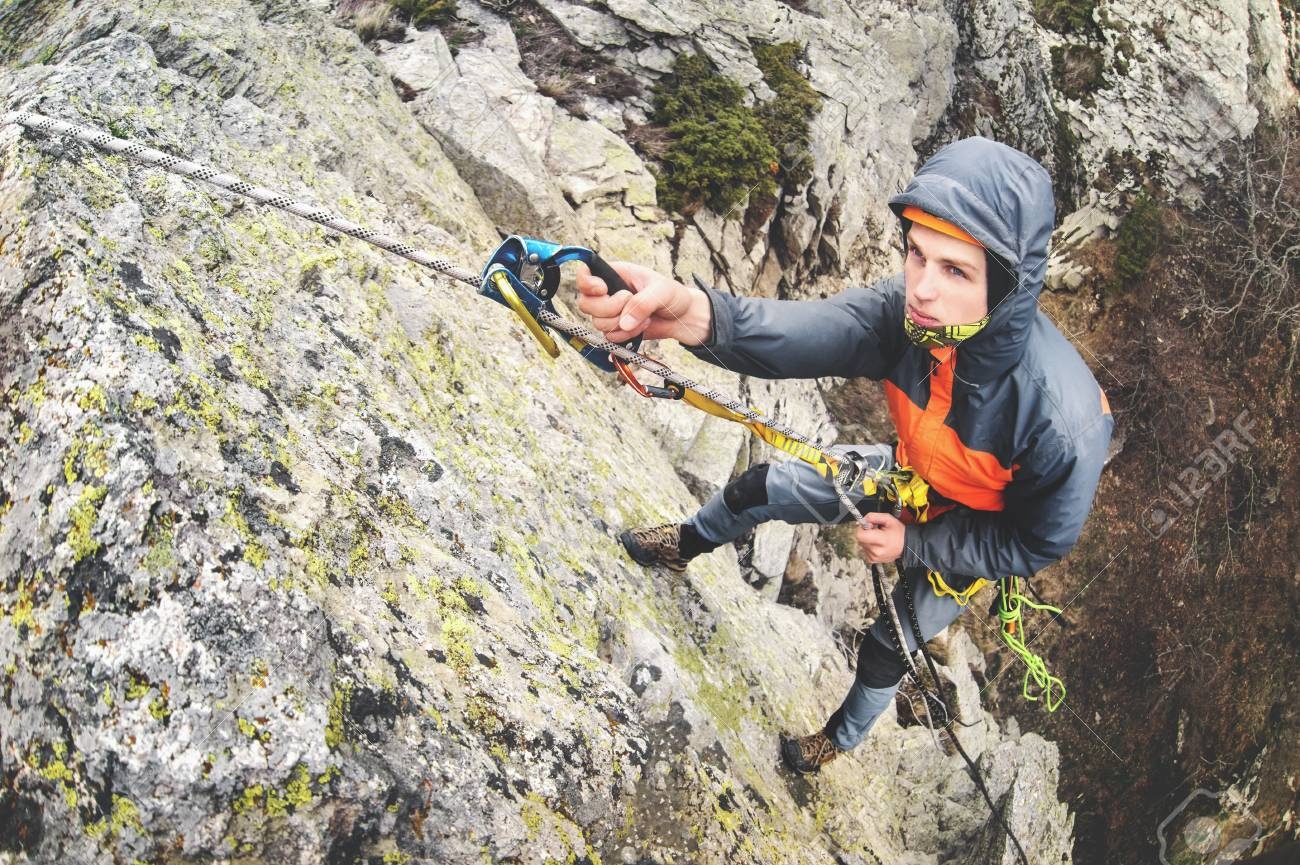 person climbing a mountain, looking determined