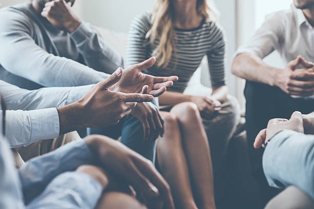 group of people communicating, showing different body language
