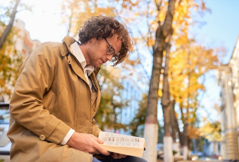 person reading a book in a park