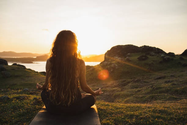 person meditating outdoors