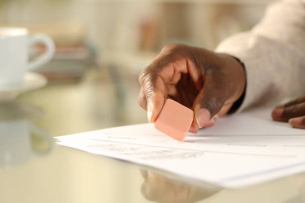 person correcting mistakes on a paper