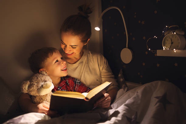 child,parent,reading,bedtime,warm light