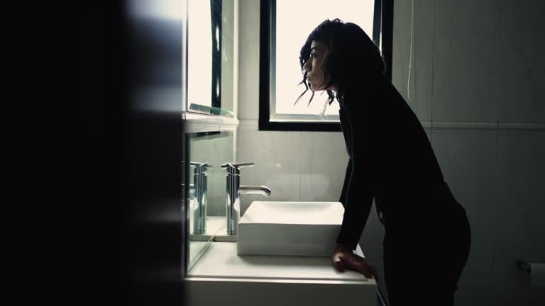 woman looking sad, scale, bathroom