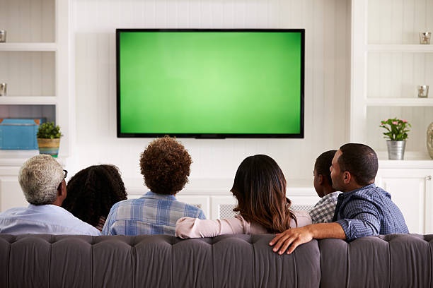 family watching tv, comfortable living room, technology