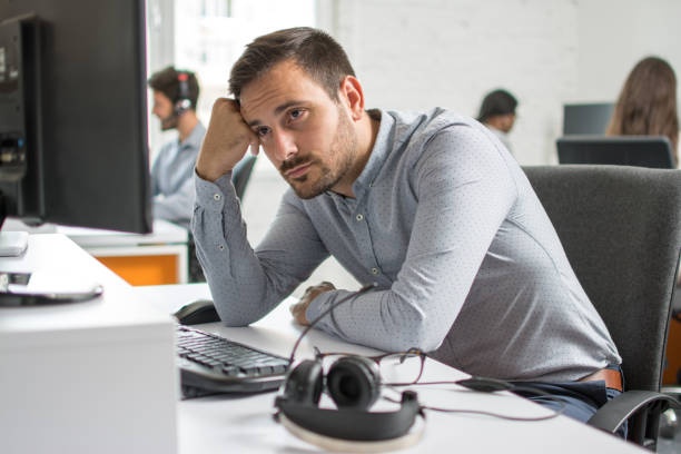 person looking stressed, desk, computer, office