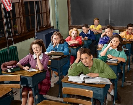 classroom, rows of desks, students looking bored