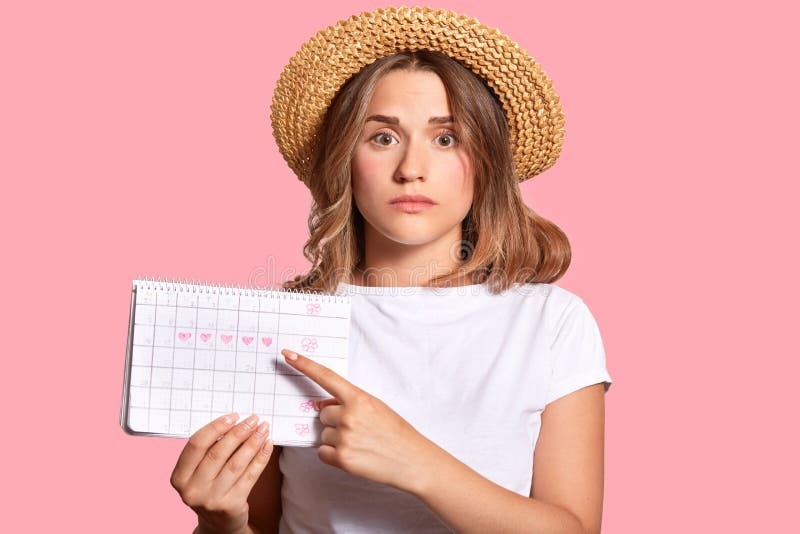 woman looking at horoscope, confused expression