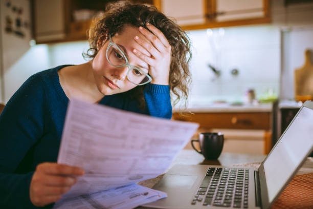 stressed person looking at bills