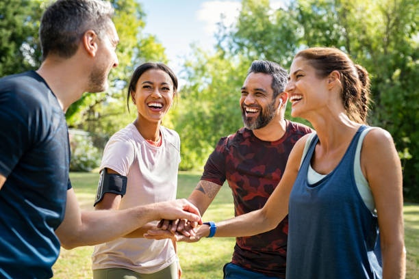 group of friends exercising together, smiling, supportive