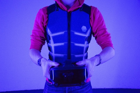 person wearing haptic vest, displaying vibrant colours, futuristic design