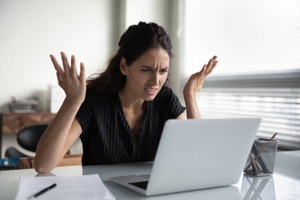 person looking frustrated at computer screen