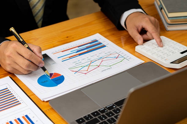 notebook,pen,financial data,income sources