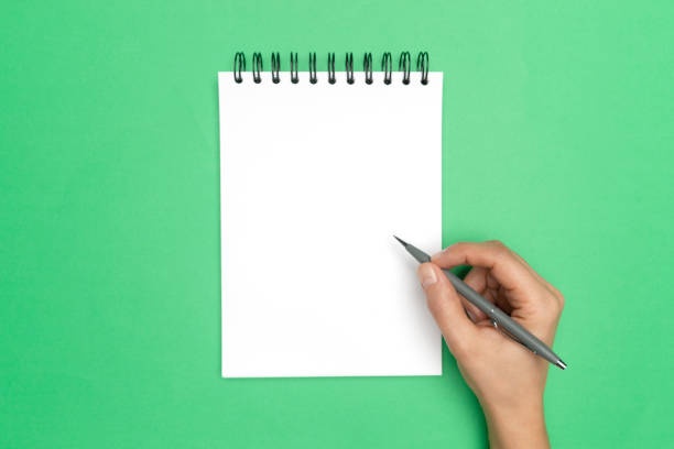 hand writing in book, pencil, notepad