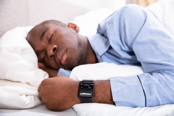 Person sleeping, smartwatch on wrist, data analysis, sleep tracking