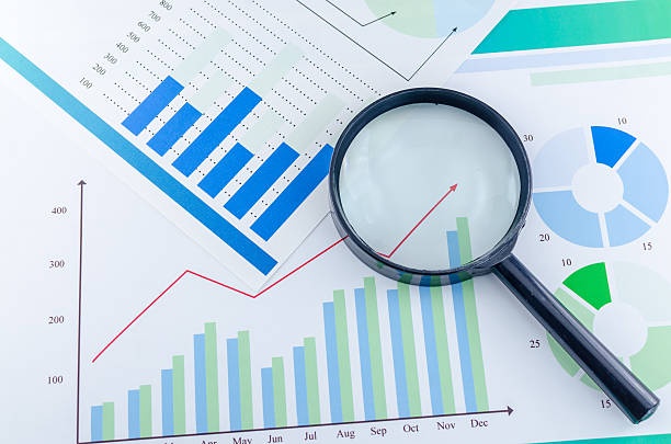 magnifying glass,investigation,documents,financial analysis